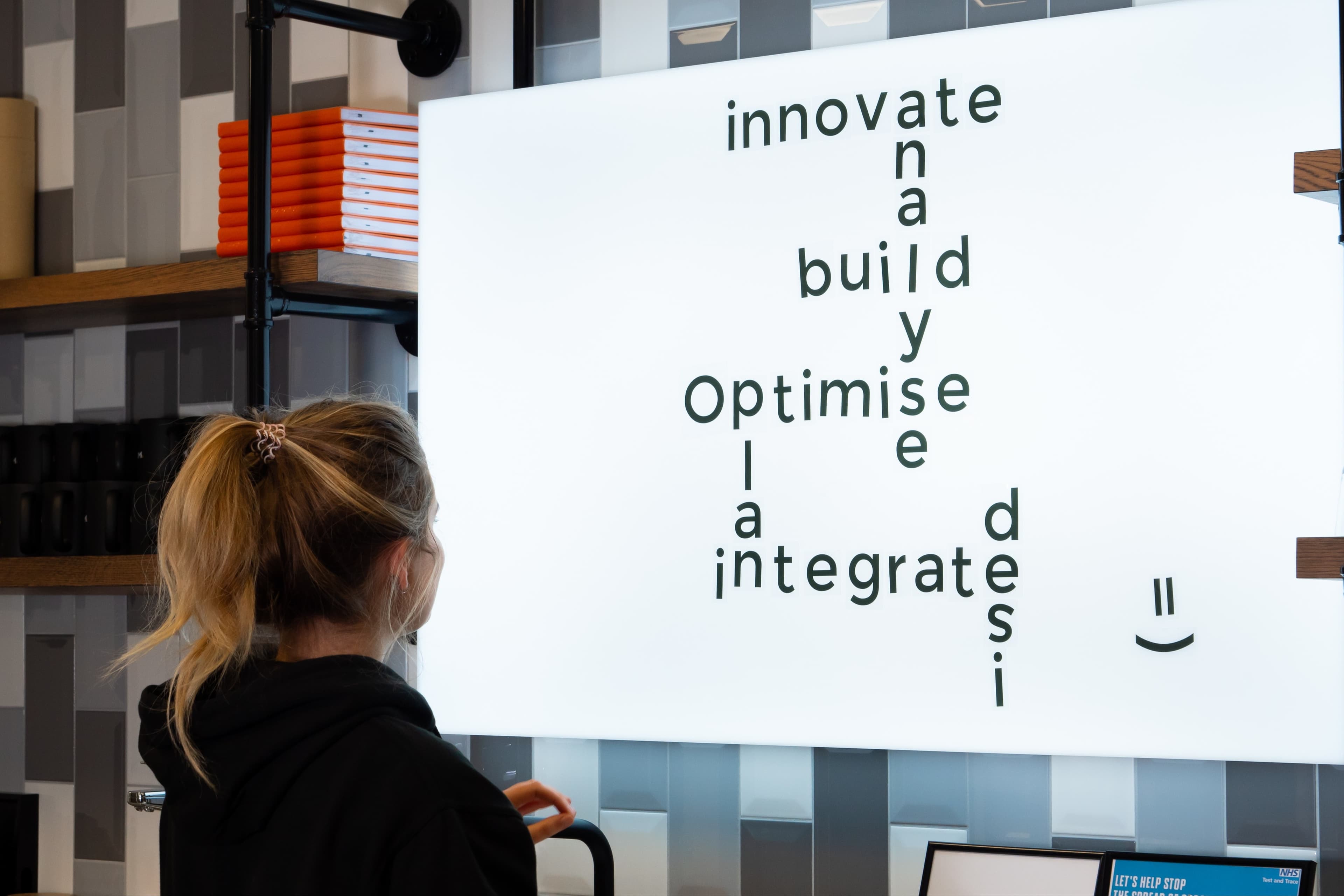 A girl looking at a board with business focused words