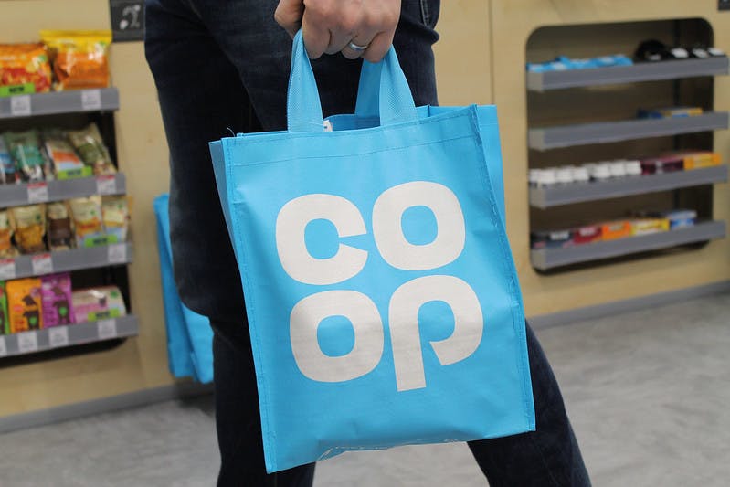 An image of a Co-op shopping bag in a supermarket