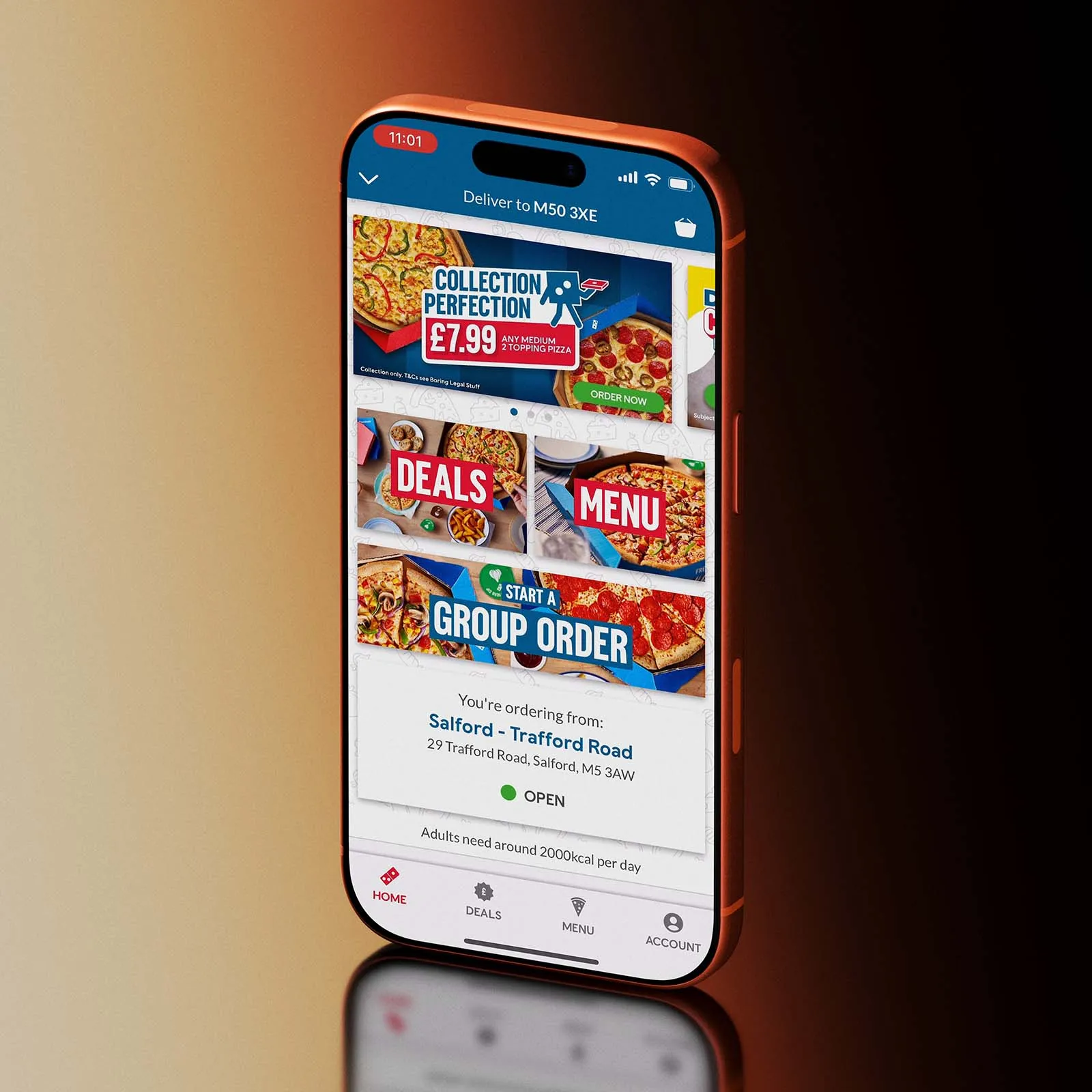 Mobile phone displaying the Domino's app, on an orange and black gradient background.