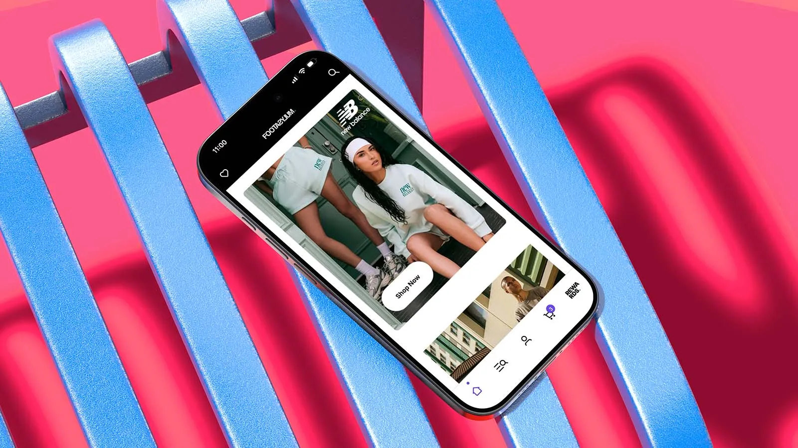 A mobile phone displaying the Footasylum app, lying on a blue slatted chair with a bright pink floor.
