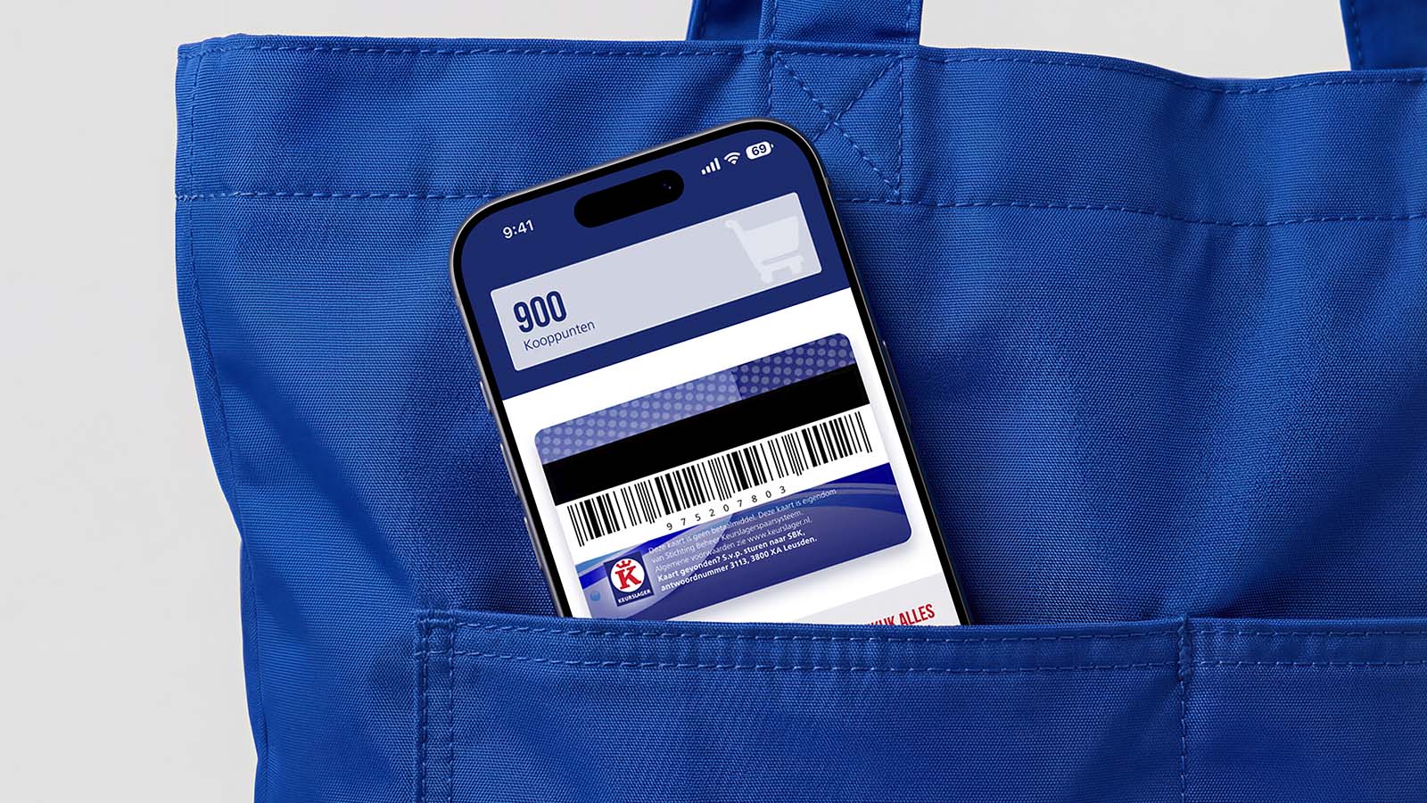 An iPhone peeks out of a blue shopping bag, displaying the Keurslager app