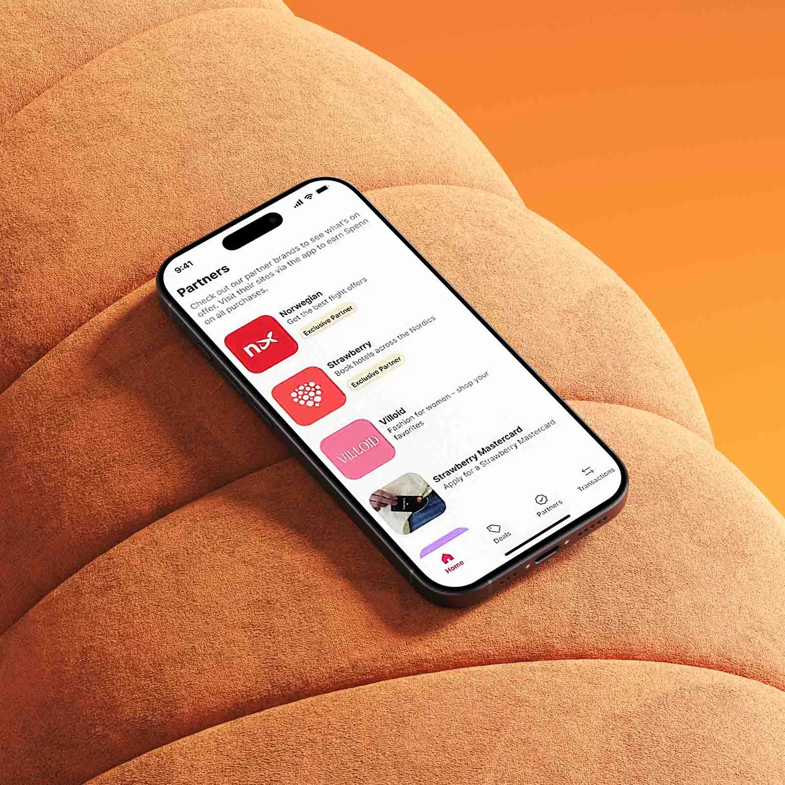A phone rests on an orange chair, displaying the Spenn app.