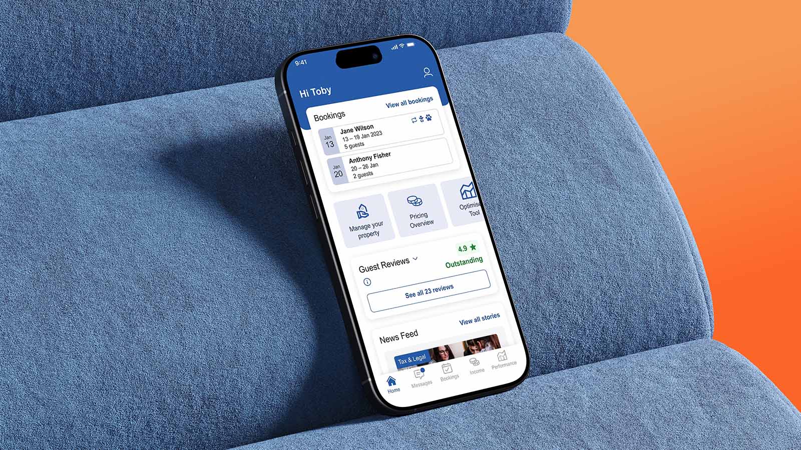 A mobile phone displaying the Sykes Owner app rests on a blue chair.