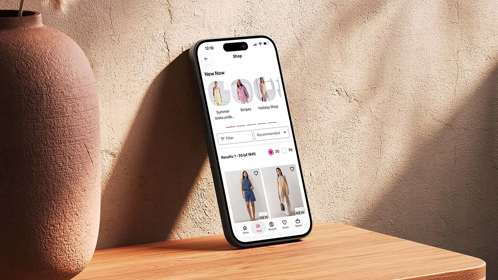 A mobile phone is propped against a wall, displaying the Very app.